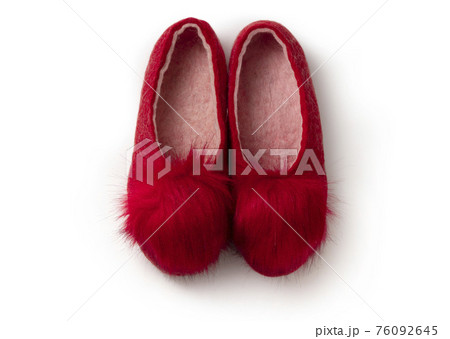 Felt slippers on white background in closeup Felt slippers on white background in closeup 76092645