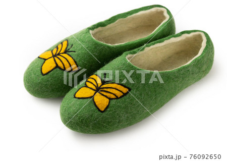 Felt slippers on white background in closeup Felt slippers on white background in closeup 76092650