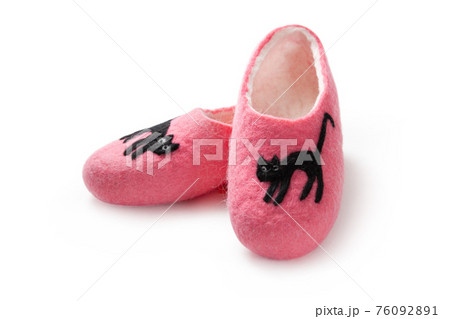 Felt slippers on white background in closeup Felt slippers on white background in closeup 76092891