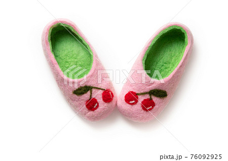Felt slippers on white background in closeup Felt slippers on white background in closeup 76092925