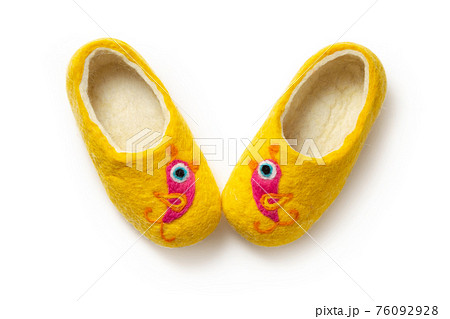 Felt slippers on white background in closeup 76092928