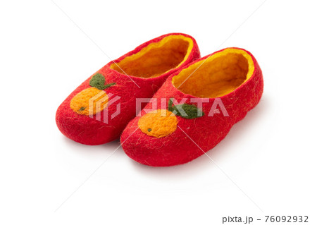 Felt slippers on white background in closeup Felt slippers on white background in closeup 76092932