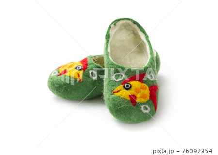 Felt slippers on white background in closeup Felt slippers on white background in closeup 76092954