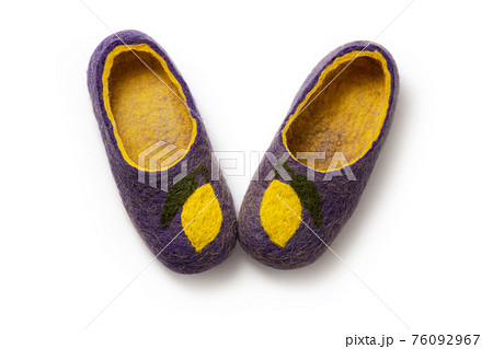 Felt slippers on white background in closeup Felt slippers on white background in closeup 76092967