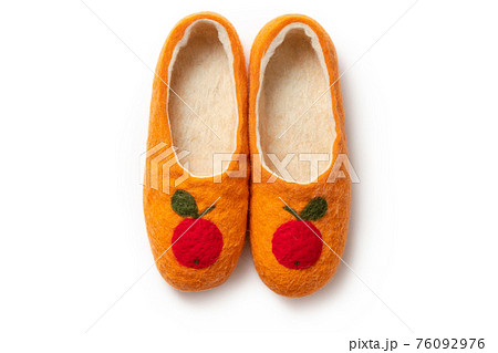 Felt slippers on white background in closeup Felt slippers on white background in closeup 76092976