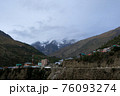 A quiet village in the middle of the mountains with snow-capped peaks in the Himalayas of India 76093274