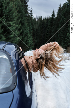 Young blonde in the car catching the wind, fast riding, travel Young blonde in the car catching the wind, fast riding, travel 76093809