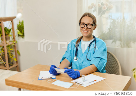 portrait smiling young woman doctor wearing blue uniform with stethoscope portrait smiling young woman doctor wearing blue uniform with stethoscope 76093810