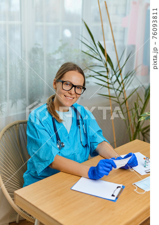 portrait smiling young woman doctor wearing blue uniform with stethoscope 76093811