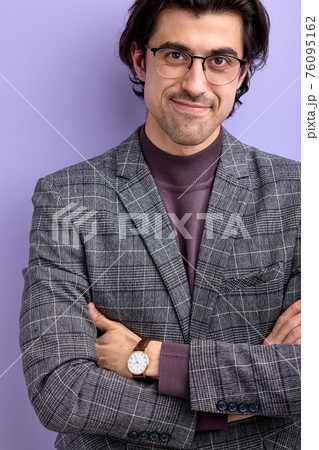 smiling nice guy in trendy suit and eyeglasses looking at camera posing 76095162