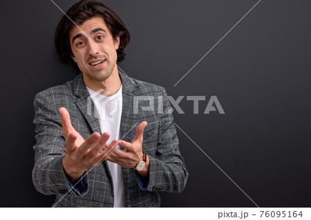 brunette guy talking gesturing with someone 76095164