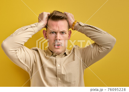 young confused man nervous about something isolated 76095228