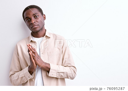 calm and wise black man keeping hands together, thinking calm and wise black man keeping hands together, thinking 76095287
