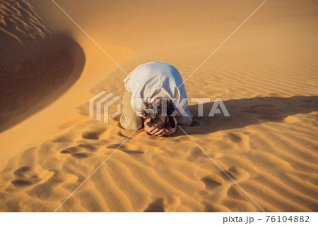 Exhausted man in the desert. Apathy, fatigue, exhaustion, mental disorders concept. Mental health 76104882