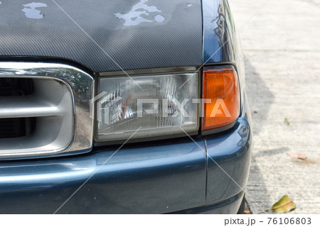 Damaged and blurred headlight surface as a result of weather condition and aging of a car Damaged and blurred headlight surface as a result of weather condition and aging of a car 76106803
