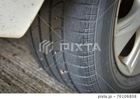 Old tire with worn tread and scratch, 76106808