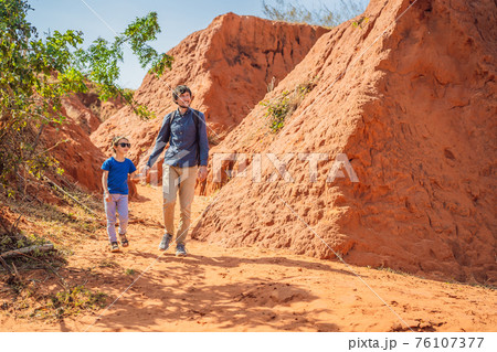 Dad and son tourists in red canyon, resumption of tourism concept. Traveling with children concept 76107377