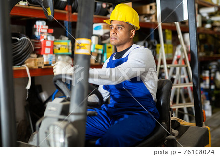 Forklift driver at the warehouse of hardware store Forklift driver at the warehouse of hardware store 76108024