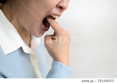 Asian woman putting her fingers in her mouth to throw up after eating food,obsessive desire to lose weight,female sticking her fingers in throat,trying to vomit diet,anorexia nervosa,bulimia concept 76108455