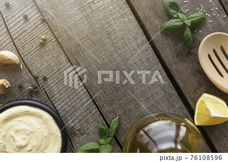 Cooking homemade mayonnaise, garlic cream sauce. Seasonings on wooden background 76108596