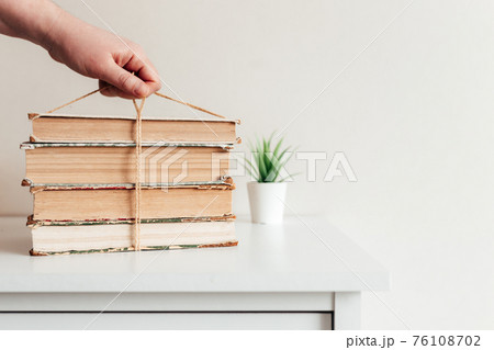 Hand holding books, concept of learning, education, science, wisdom, knowledge Hand holding books, concept of learning, education, science, wisdom, knowledge 76108702