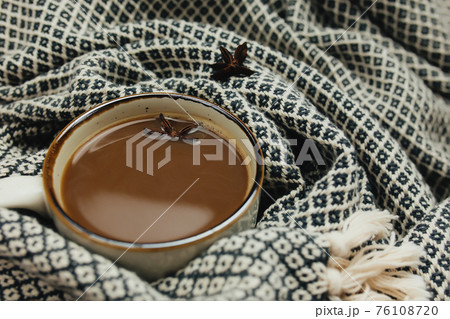 Cup of coffee on table with plaid Cup of coffee on table with plaid 76108720