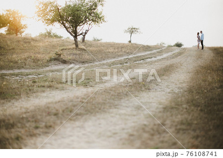 Lovely couple outdoor has romantic photo session. Blurred background Lovely couple outdoor has romantic photo session. Blurred background 76108741