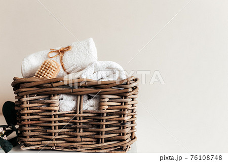 Basket with bathroom accessories. A set of rolled towels. Hotel cleaning concept 76108748