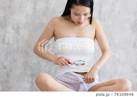 Woman Looking At The Crotch With A Loupe Stock Photo