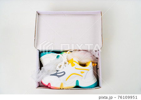 new multi-colored sneakers in box on a white background.  76109951