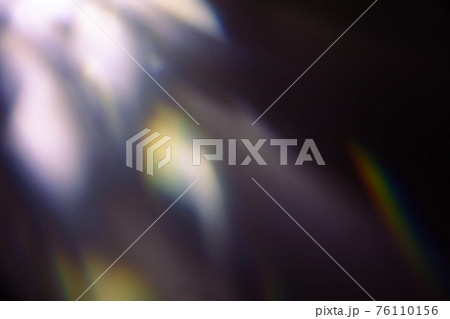 colorful warm rainbow light leaks on black background with dust texture 76110156
