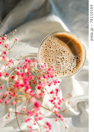 Cup of latte cappuccino. Morning coffee aesthetics vibes. Breakfast. Pink gypsophila flowers Cup of latte cappuccino. Morning coffee aesthetics vibes. Breakfast. Pink gypsophila flowers 76110164
