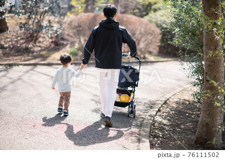父親と公園を散歩する男の子・男性の子育てイメージ 父親と公園を散歩する男の子・男性の子育てイメージ 76111502
