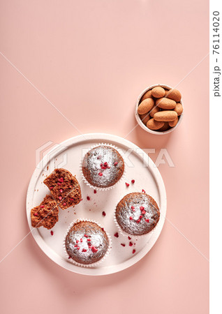 Homemade chocolate cupcakes in baking paper forms and piece of it Homemade chocolate cupcakes in baking paper forms and piece of it 76114020