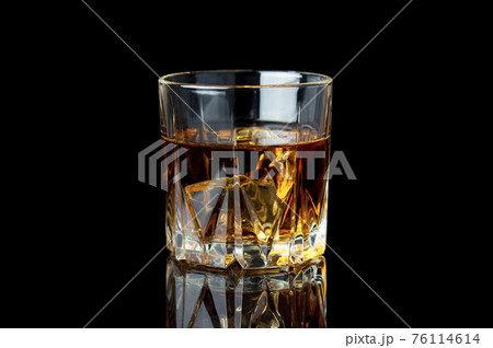 Glass of whiskey and ice. Glass of whiskey and ice. 76114614