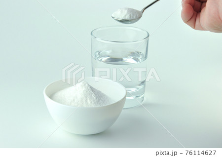 Baking soda, spoon and glass of water. Baking soda, spoon and glass of water. 76114627