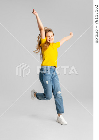 Happy kid, girl isolated on white studio background. Looks happy, cheerful, sincere. Copyspace. Childhood, education, emotions concept 76115102