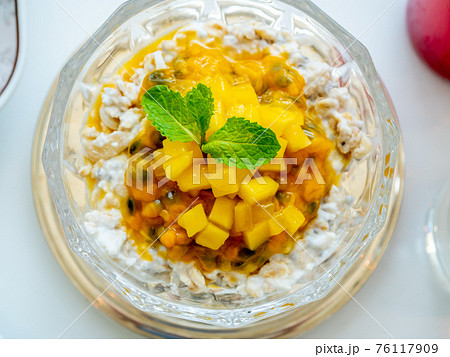 Breakfast muesli with mango in luxury hotel  76117909