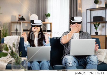 Excited chinese family using VR glasses for having fun at home 76118211