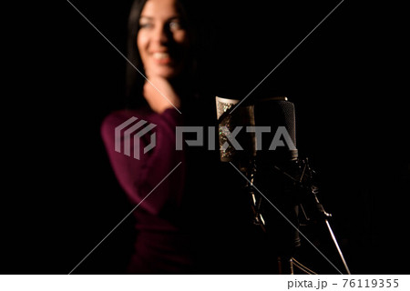 Portrait of woman recording a song in a professional studio Portrait of woman recording a song in a professional studio 76119355