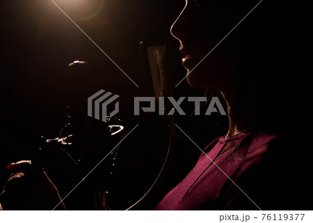 Singer recording a song in music studio. Singer recording a song in music studio. 76119377