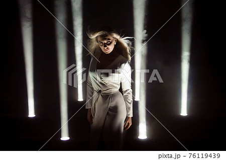 Woman club lights party background Dancing girl Long hair. Plus size artist posing in a beam of Woman club lights party background Dancing girl Long hair. Plus size artist posing in a beam of 76119439