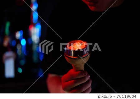 Shisha hookah, red hot coals. Man blows coals for sparks fly. Shisha hookah, red hot coals. Man blows coals for sparks fly. 76119604