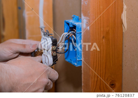 Replacing old broken an electrical outlet into the wall box 76120837