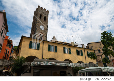 Monterosso, Liguira, Italy. June 2020. In the historic center of the village the ancient clock tower dominates the scene. Beautiful summer day. 76122252
