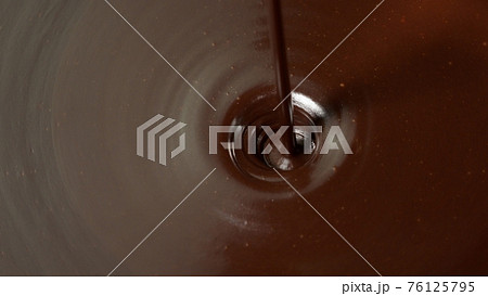 Pouring premium dark melted hot chocolate, process of making confectionery sweet desserts, icing 76125795