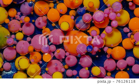 Ink bubbles mixed with liquid substance of oil, milk, soap, bright acrylic paint on colorful surface 76126118