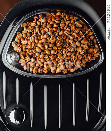 coffee beans in coffeemaker bean container, top view 76126619