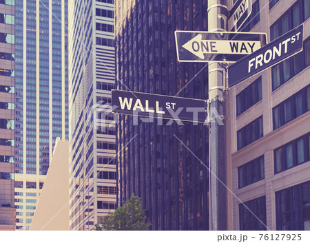 Wall Street and Front Street signs on a post, selective focus, color toning applied, New York City, USA. Wall Street and Front Street signs on a post, selective focus, color toning applied, New York City, USA. 76127925