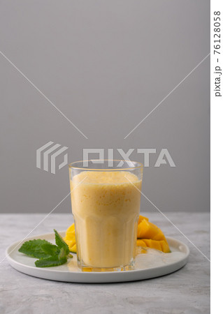 Lassi is a popular traditional yogurt based cold drink with mango in India 76128058
